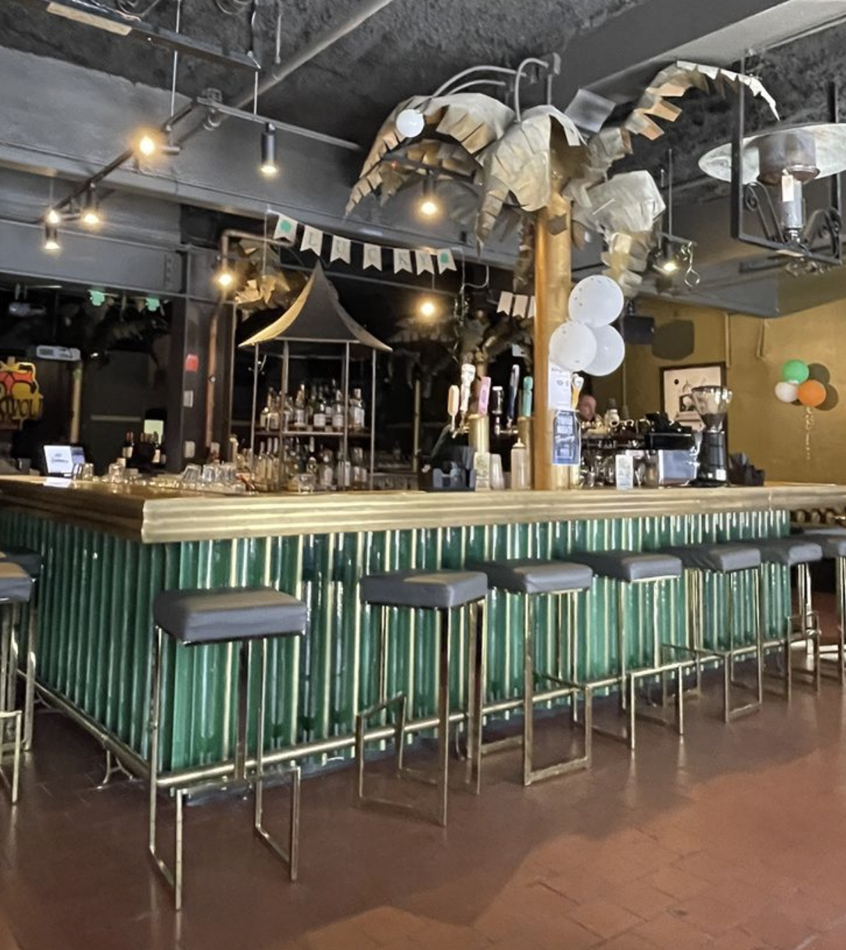 Savoy Tivoli interior — green tile bar, brass fittings, and the palm tree above