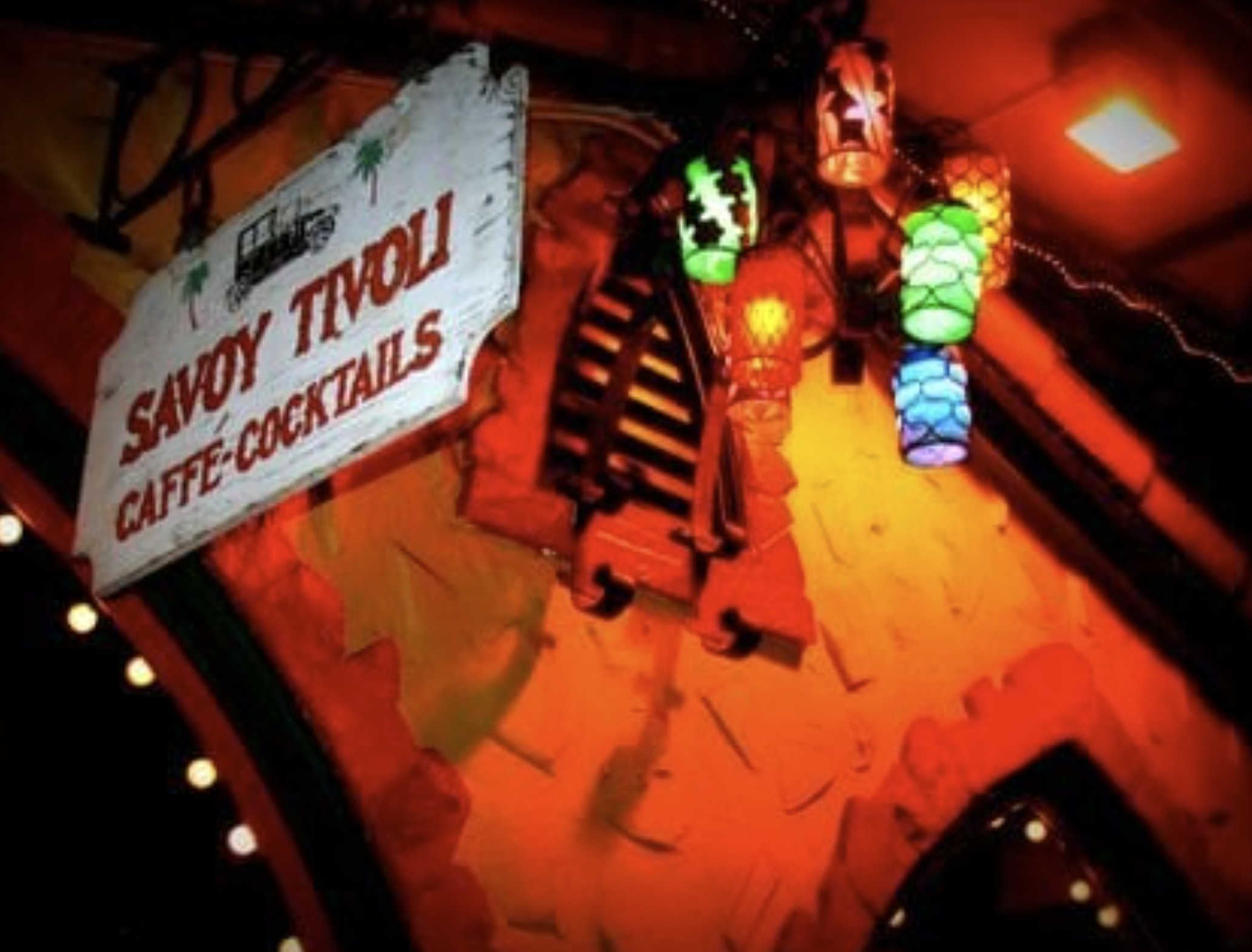 Savoy Tivoli sign at night, glowing with colorful lanterns
